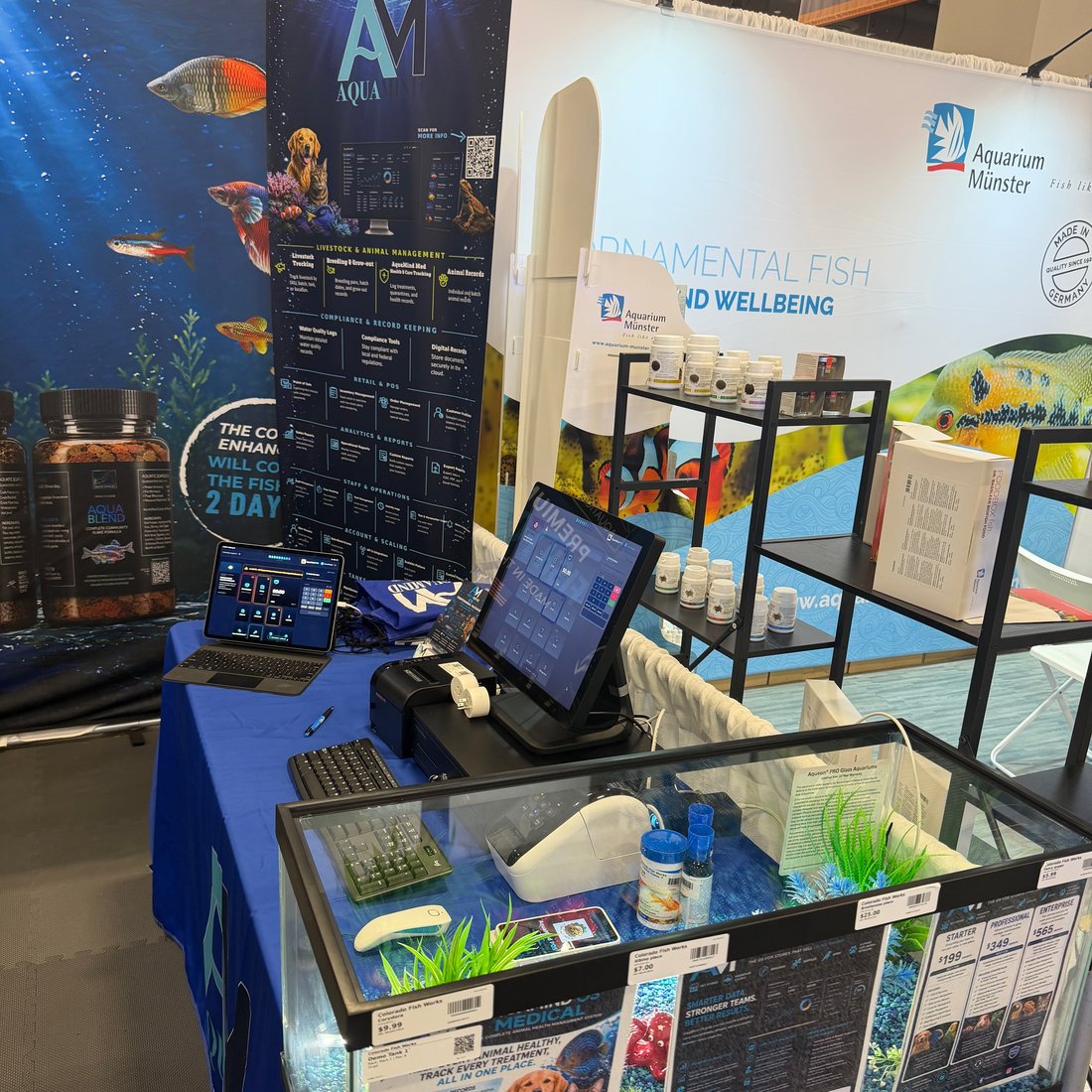AquaMind booth: POS register, dashboard tablet, receipt printer and aquariums