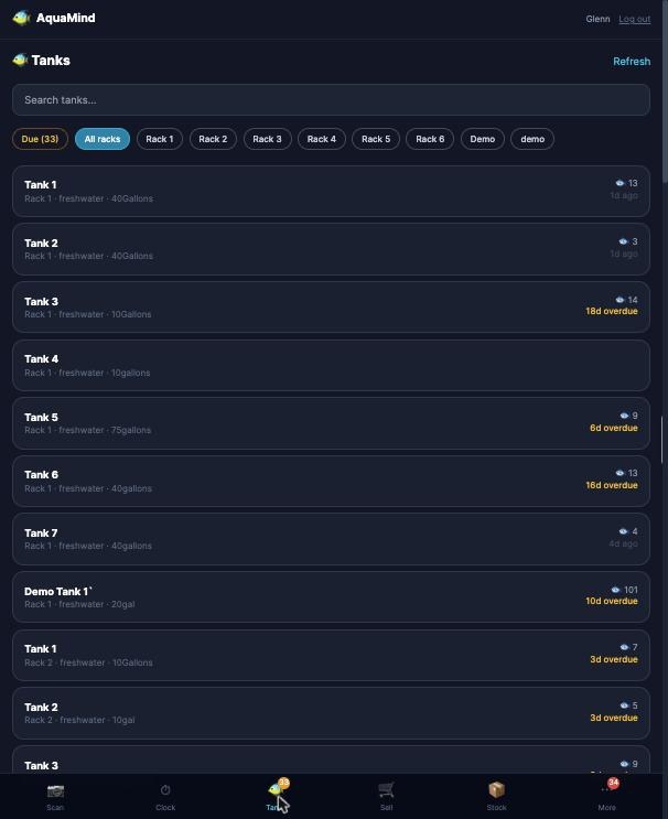 AquaMind on a phone showing the tank list with water-change reminders